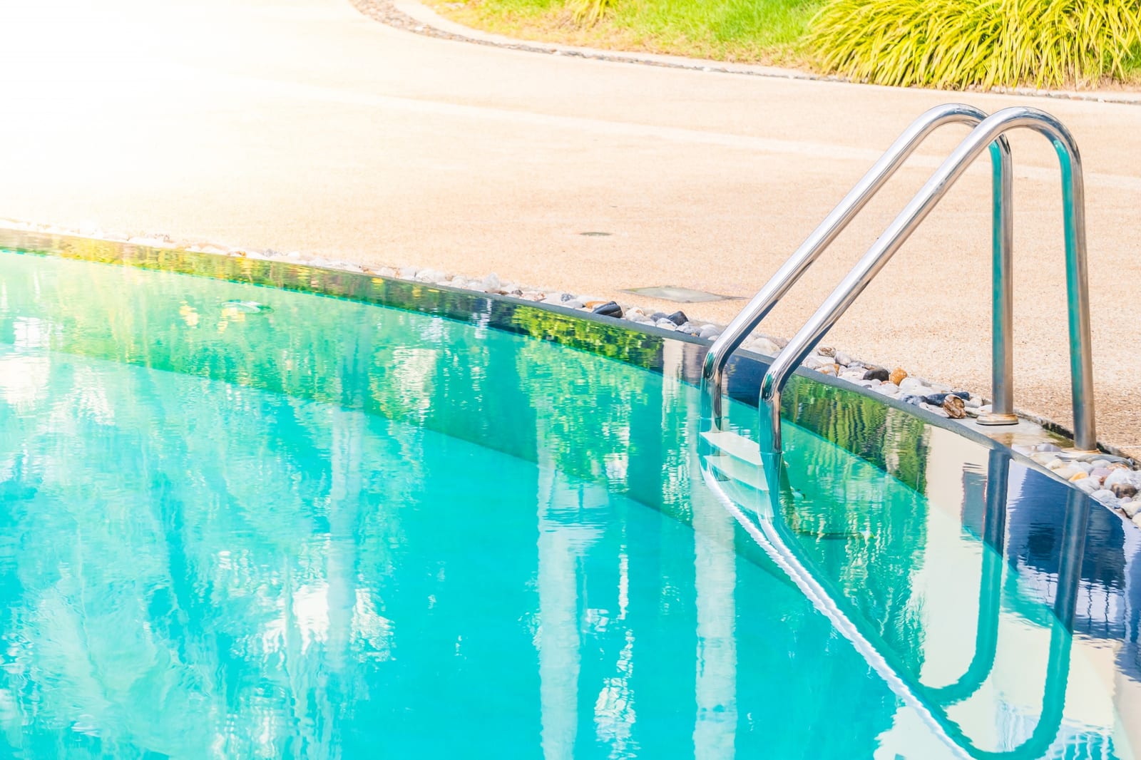 Technician testing pool water chemistry poolside with a test kit in Calgary