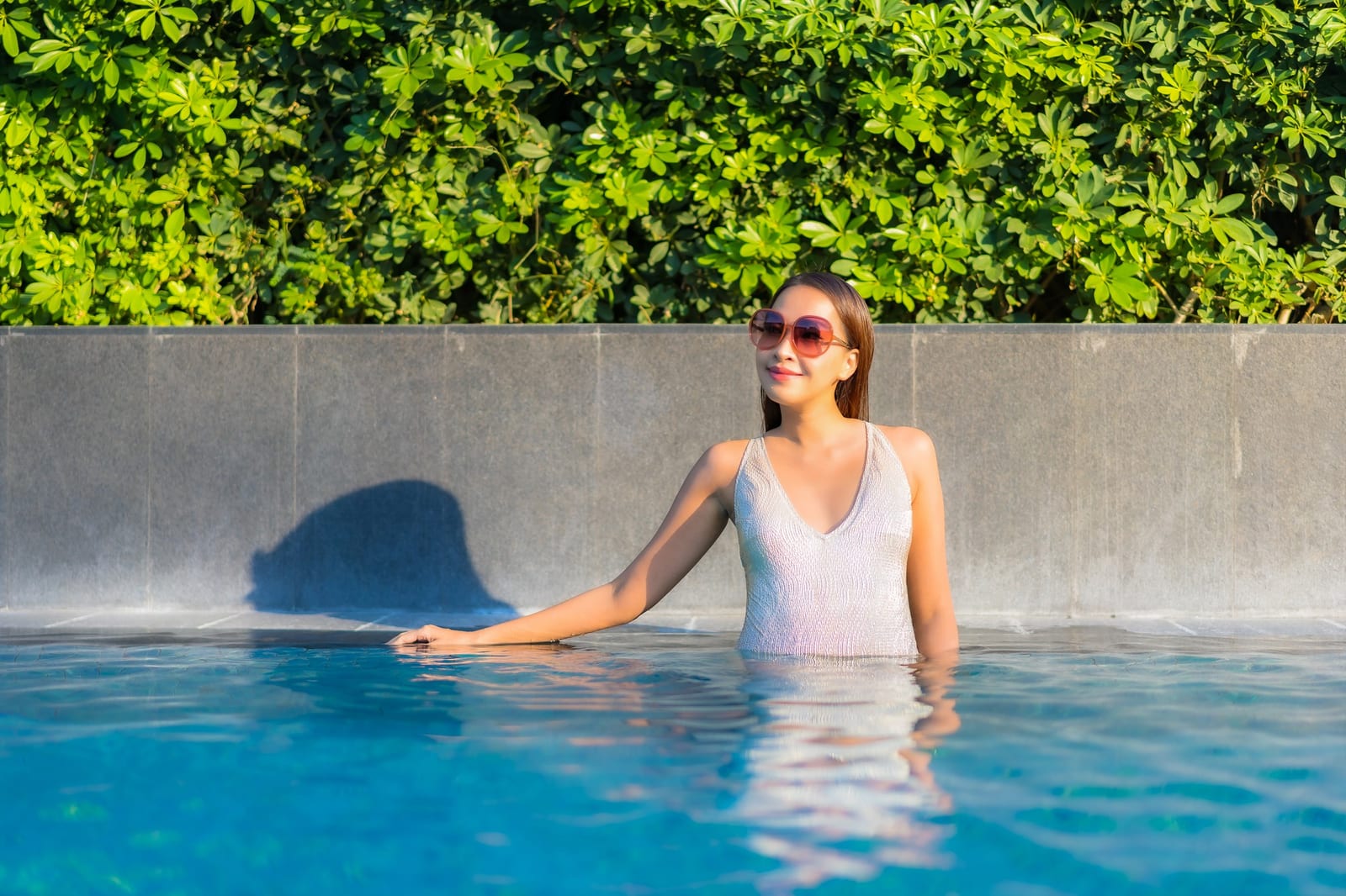 Residential backyard pool lit in the evening after a seasonal service stop